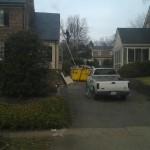 Dumpster propping up ladder